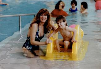 Justin burns, who turns 4 on Monday, practises, with his mother Ann, for his swim for heart fitness
