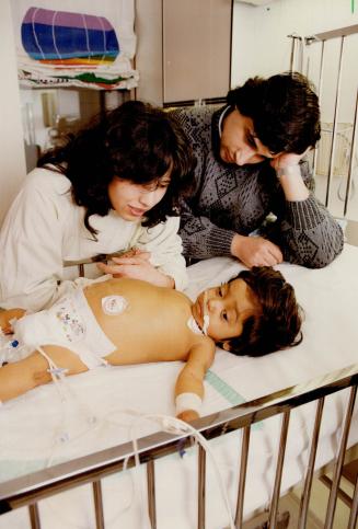 Lidia and Carios Gutierrez keep a vigil at the bedside of son Mauro, 20 months, in Children's Hospital in London, Ont