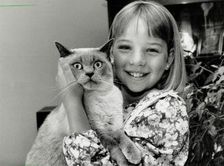 Cancer recovery: Tara Mckinnon, 10, of Aurora, shown yesterday with her cat Ming, wants other children to know leukemia can be beaten