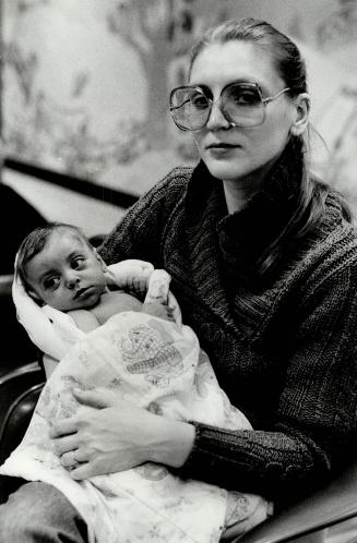 Mrs. Carol Needham, holding her daughter Kathleen, 5 month old. This same case us above Lindsay