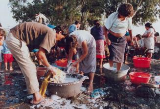 Cholera Peru - Villagers washing clothes at well just outside Lima