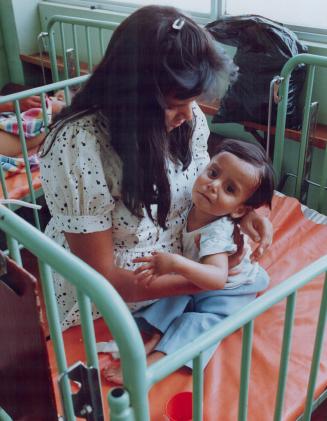 Cholera - Peru - Young girl is comforted by her mother at Hospital De Apoyo Maria Auxiliadora