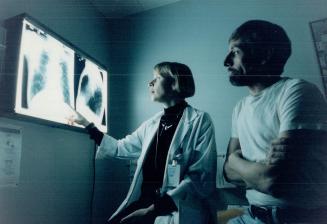 Dr. Elizabeth Tullis shows CF patient John Hoddy his X-rays