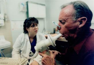 Bill Eakins being given respiratory test by Karen Boardman Wellesley Hospital
