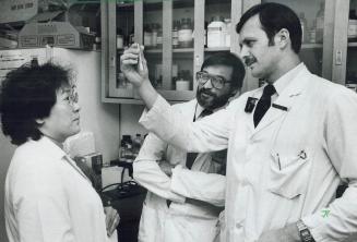 Major breakthrough: Dr. Mohamed Karmali, left, and Martin Petric, a virologist, examine a sample at the Hospital for Sick Children. The two are part o(...)