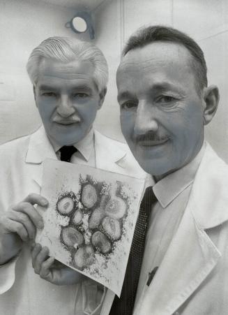Hong Kong Flu Virus photograph, showing the virus magnified 500,000 times, is held by Joseph Hamvas and Dr. Nicholas A. Labzoffsky at the virus labora(...)