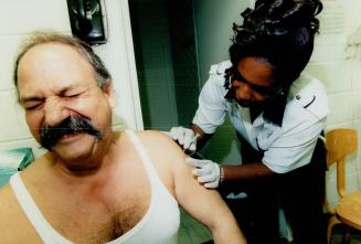 Sharon Thomas gives Vaccination to Peter Soumbalis