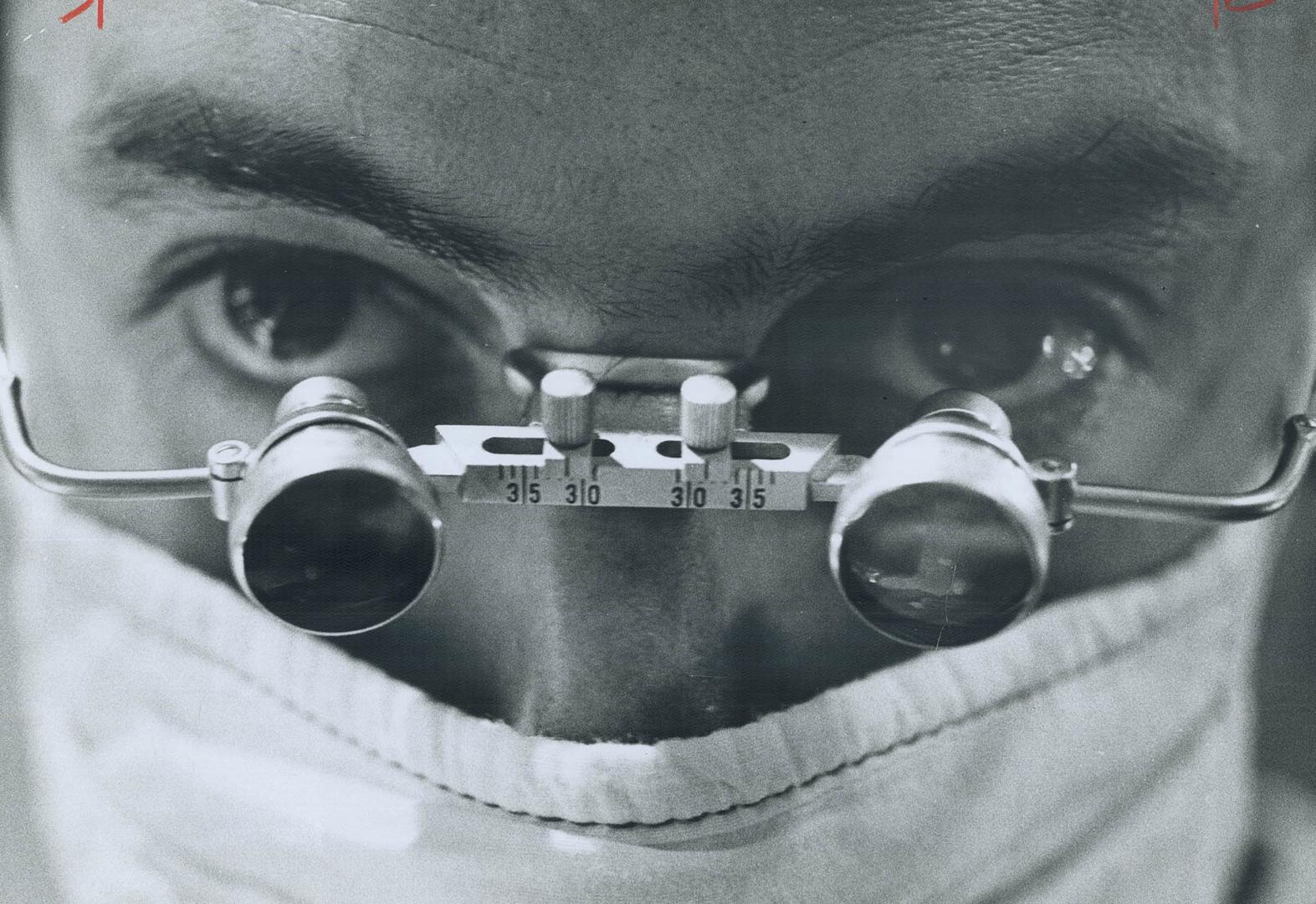 Magnifying spectacles were worn by surgeon during delicate transplant operation as he sliced away corneal tissue that was only tiny fractions of an in(...)