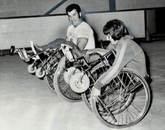 Gene Reimer (left) of Vancouver, Canada's 1972 wheelchair athlete of year, and Chris Stoddard of Toronto demonstrate manoeuvre on their wheelchairs at(...)