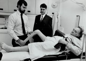 New and improved: Drs. Peter Brooks, left, and Richard Zarnett observe Derek Wade's knee at Mount Sinai Hospital