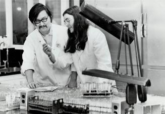 Technologists Peter Yaswnobw and Miss Maxine Wodmeyer with Blood Specimens to be tested for VD Ontario Government's Central Laboratory Highway 401 & Islington Ave