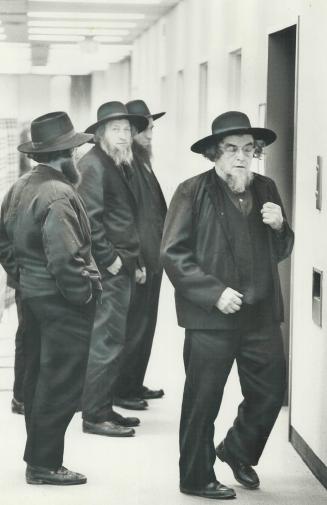 Amish farmers take a break yesterday during the Ontario Milk Commission hearing