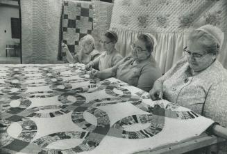 Quilting bees like this one in Hillcrest Mennonite Church are held each year prior to the Relief Sale