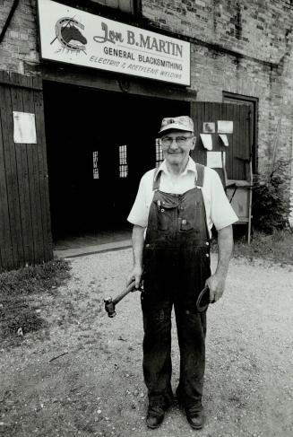 Town blacksmith: Jon Martin still fixes wagon wheels and pounds red hot horseshoes on his anvil as he did 40 years ago, but much of his business is repairing farm machinery