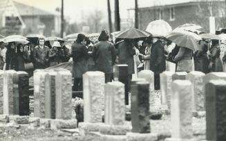 Mourners gather in yesterday's rain at Debbie Silverman's funeral in Bathurst Lawn Memorial Park
