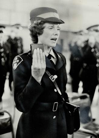 Women join Opp ranks, Among the first women sworn into the Ontario Provincial Police, Mrs Diane Brock takes the oath at Moss Park Armories Yesterday. 14 other women were among graduates