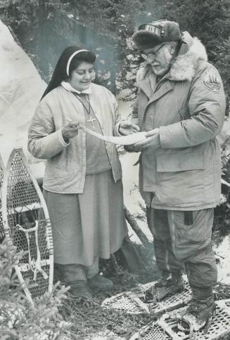 Sister Madeline Martineau, born in a village on the shores of James Bay, shows instructor Berndt Berglund a wooden scoop she carved. On trips, she uses it as a snow-scraper and soup spoon