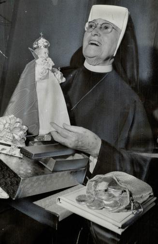 Sister Patricia looks over some of the many gifts received for her 50 years of service as nun