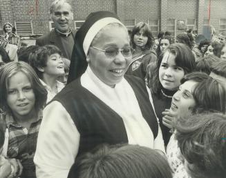 The Angel of Honduras, Sister Maria Rosa is surrounded by pupils at St