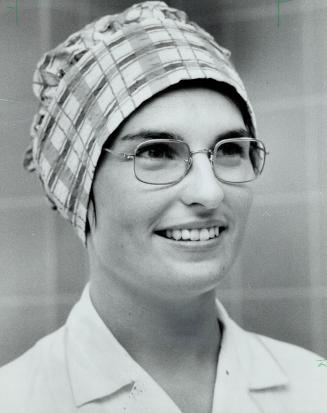 Judy Gilbert sports a bit of individuality in her surgery headgear which is made of cotton plaid in shades of blue