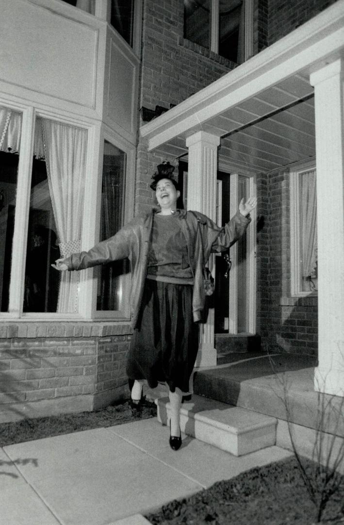 Luck of the Irish: Dorothy Thibodeau, a nurse at Queen Street Mental Health Centre, kicks up her heels in front of the $250,000 home she won in the Centenary Hospital draw