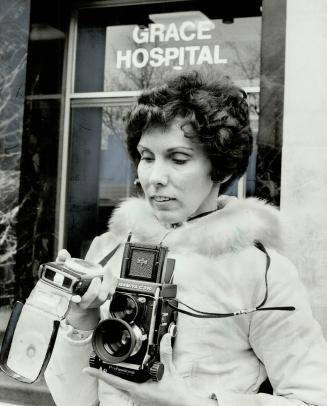 Compiling an Album for a ward of Metro Children's Aid Society, amateur photographer Mary Cook gets set to take a picture of hospital where child was b(...)