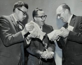 Silver Dollars -$300 worth - pour into hands of James Griffin of Toronto after he was named photographer of year by Commercial and Press Photographer'(...)