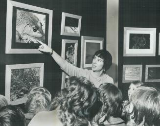 Jean Florence Hart explains work to children, Her photographs taken in Muskoka area have been on exhibition at ROM