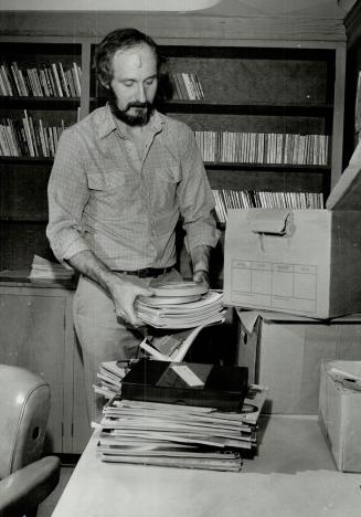 Mace Armstron, of the Joint Forces Project P Special Investigation Branch, as he loads Porno magazines into box along with (confiscated) 8MM films & Video Tapes