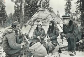 Stranded while trapping along Hudson Bay where shrub trees give way to open tundra, the Chookomilin Indian family-Albert, his wife, Helen, and his sis(...)