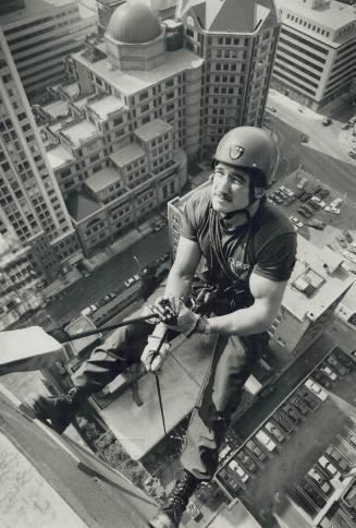 Staying on top of his job, Ontario Provincial Police officer Dave Milne rappels down a 19-storey Grosvenor St