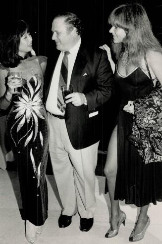 Above left, model-actress Bernadette Li, who was Miss Toronto 1984, chats with actor Al Waxman and Vancouver film producer Elvira Lount. Li wore a dress of her own design