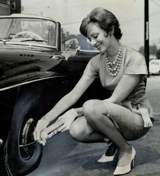 Hocus, Pocus-Here's How you fix flat, Model Jean MacDonald seals, inflates tire with rubber compound product