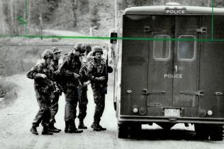 Ready to go: Members of the Ontario Provincial Police Tactics and Rescue Unit had a real workout this week with hunts for two murder suspects, one in the huntsville area and the other near Arthur