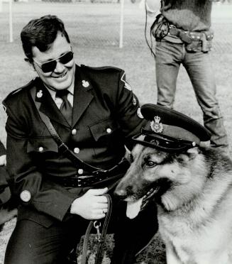 Rebel's ruff and ready for duty, Ontario Provincial Police Constable Bill Horseman congratulates Rebel, one of four canine recruits to make the grade (...)