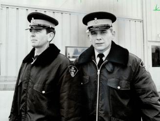 Cpl. Bev Brintnell (left) & Constable Dave Hoover (Facing camera)