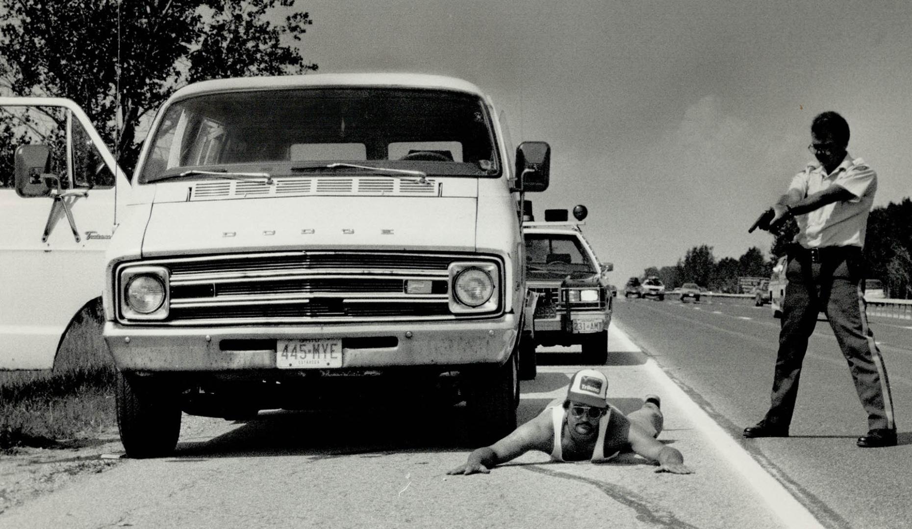 Taking no chances, OPP Constable Dana King trains his gun on Robert Yurko, 29, of Parma Heights, Ohio, after stopping his van on Highway 400 in the Ba(...)