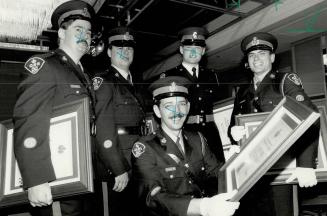 Bravery noted: OPP Constable Mark Meers, left, student Kimberly MacKenzie and pharmacist Ian Reynold Stewart were among 19 people honored for valor by the Ontario Provincial Police