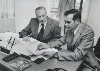 Staff Superintendent Jack Kay (left), head of the Ontario Provincial Police anti-rackets squad, goes over files with Det.-Sgt. Ralph Smith. The squad (...)