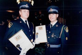 OPP Detective John Uttley, left, and Constable Graham Thorpe received the Ontario Medal for Police Bravery yesterday for saving a 68-year-old man and (...)
