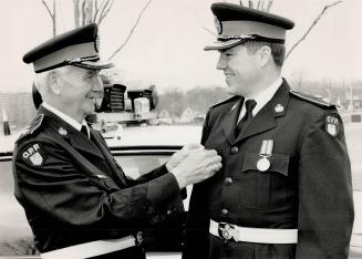 . . . And the new, Ontario Provincial Police Superintendent Bill MacGregor, retiring yesterday after serving on the force 34 years, passes the job of (...)