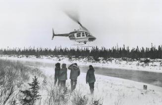 The New Helicopter of the Ontario Provincial Police takes off with four members of an Indian family stranded near Hudson Bay while others in the famil(...)