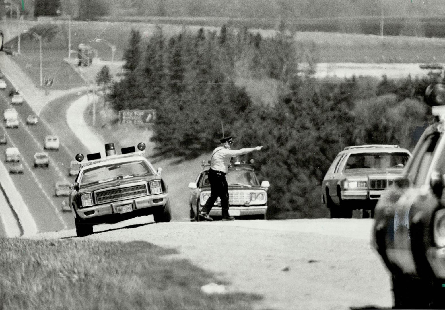 Pull over!, OPP officer flags down a vehicle on Highway 400 north of Metro