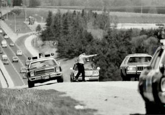 Pull over!, OPP officer flags down a vehicle on Highway 400 north of Metro