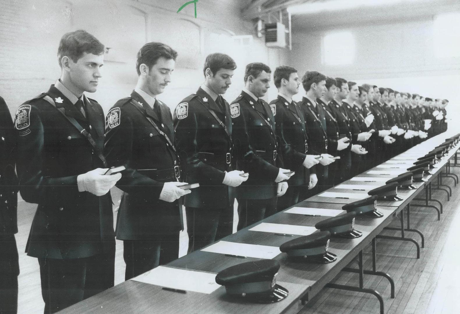 Tunes of glory? Recruits to Peel Regional Police are seen taking oath of office