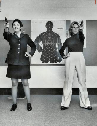 Taking, aim, the two women on the Durham Regional Police force practise their shooting on the police range