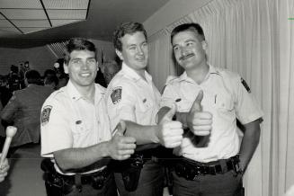 Got their man: From left, Peel Constables Warren Gherasim, Jayme Prevett and Thomas Keya celebrate their unexpected capture of Frederick Merrill