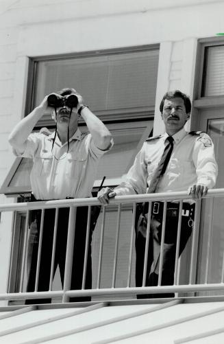 Lake lookouts: Peel Regional Police marine unit officers Marc Crawley and Dough Poirier, with binoculars, get a good view from the new headquarters