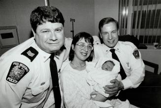Peel Region Police Sgt, Mike Grodzinski (left) and Const Bruce Thomson with Nancy Kodlowski and baby