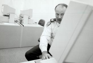 Peel police sgt. Paul Beatty With CD-Rom -based computer system